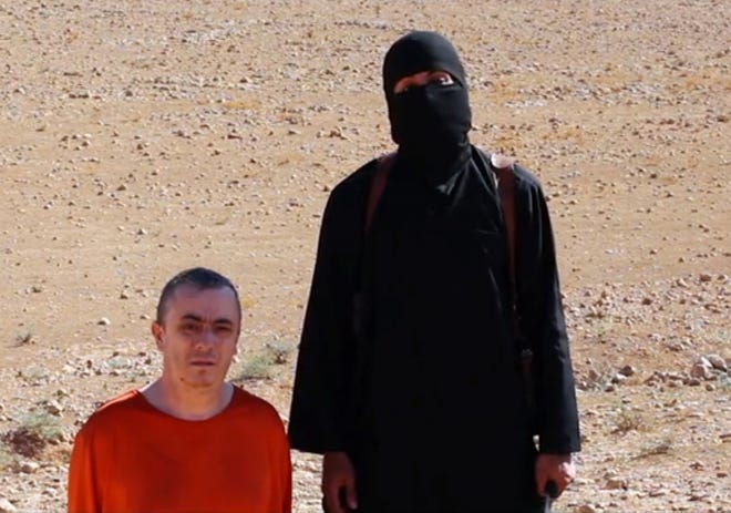 This undated image shows a frame from a video released Oct. 3 by Islamic State militants that purports to show the killing of Alan Henning.