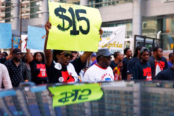 Protestors demonstrate to push fast-food chains to pay their employees at least $15 an hour in Philadelphia last month.