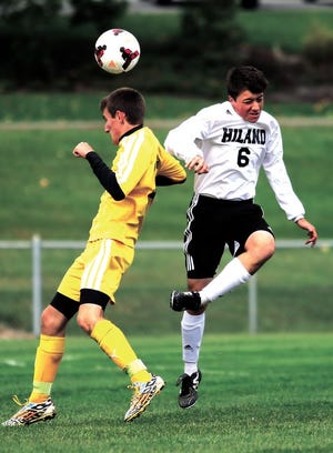 Hiland High School’s Brady Conn battles Waynedale’s Brady Troyer for the ball during Saturday’s match at Hiland. The Hawks won the match 3-2.