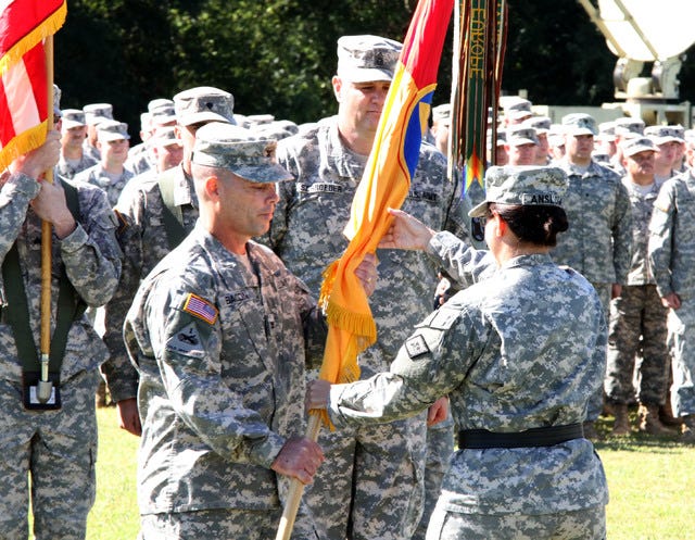 Jamie Mitchell • Times Record - Incoming commander Col. Gregory Bacon, left, accepts the 142 Field Artillery Brigade guidon from Brig. Gen. Patricia Anslow on Saturday, Oct. 4, 2014, during the brigade change-of-command ceremony at Fort Chaffee. 
 Jamie Mitchell • Times Record - Incoming commander Col. Gregory Bacon, left, accepts the 142 Field Artillery Brigade guidon from Brig. Gen. Patricia Anslow on Saturday, Oct. 4, 2014, during the brigade change-of-command ceremony at Fort Chaffee.