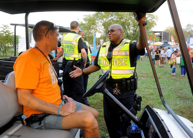 Columbia police Officer Curtis Brown talks with Scott Robbins Sept. 26 at the Roots N’ Blues N’ BBQ Festival.