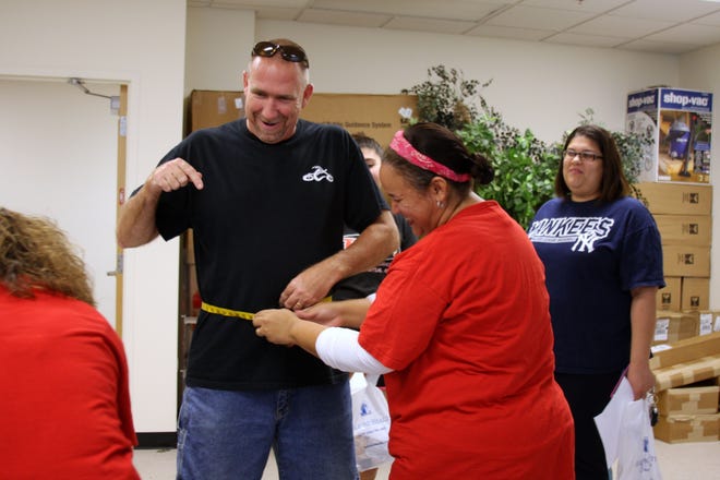 Cornerstone Church fitness team member Sandy Hovis jokes with the nurses from Florida Hospital Fish memorial during his initial weigh-in and measurements for the Mayor's "Get Fit in 15" Fitness Challenge at Deltona city hall.