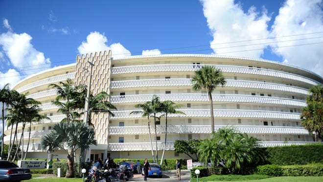 Officers respond to a shooting at The President of Palm Beach condominium Friday.