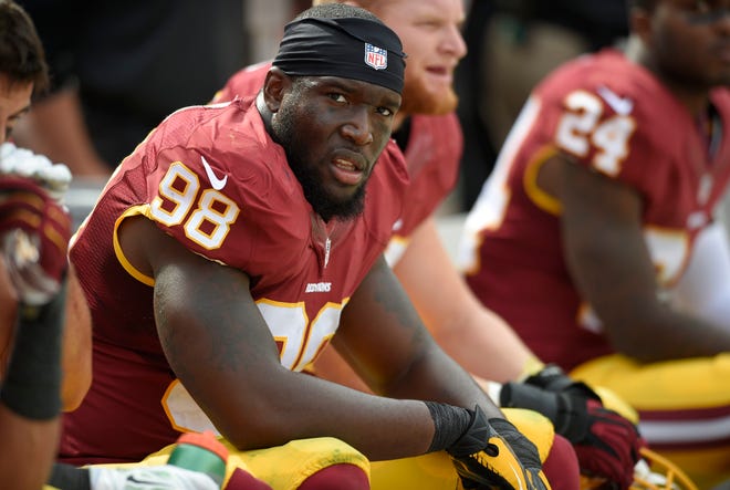 Washington Redskins outside linebacker Brian Orakpo (98) looks on from the bench during the second half of an NFL football game against the Jacksonville Jaguars, Sunday, Sept. 14, 2014, in Landover, Md. The Redskins won 41-10. (AP Photo/Nick Wass)