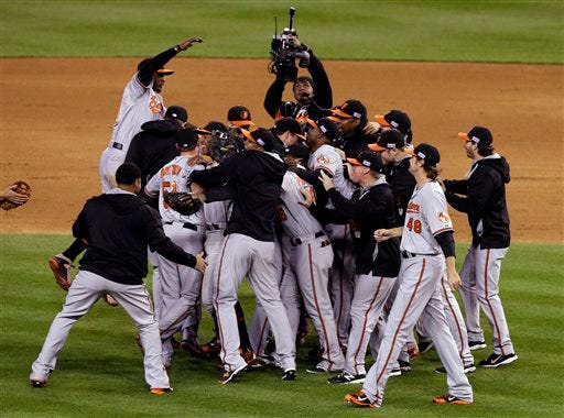 Baltimore Orioles players celebrate after defeating the Detroit Tigers, 2-1 in Game 3 of baseball's AL Division Series Sunday, Oct. 5, 2014, in Detroit. Baltimore won the series 3-0. (AP Photo/Darron Cummings)
