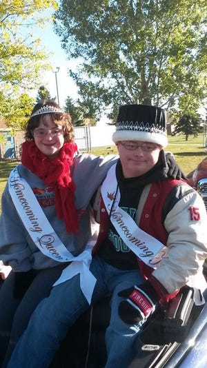 DLHS 2014 Homecoming King Alex Paulson and Queen Cassidy Shereck on their royal carriage in the Homecoming parade on Saturday, Oct. 4.