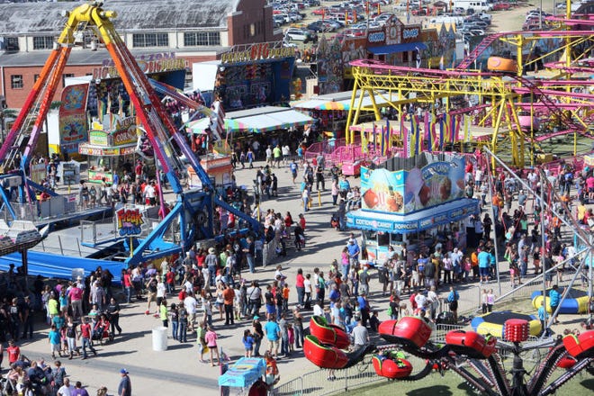 Fair attendees walk the midway during at the Kansas State Fair on Sunday, Sept. 14, 2014.