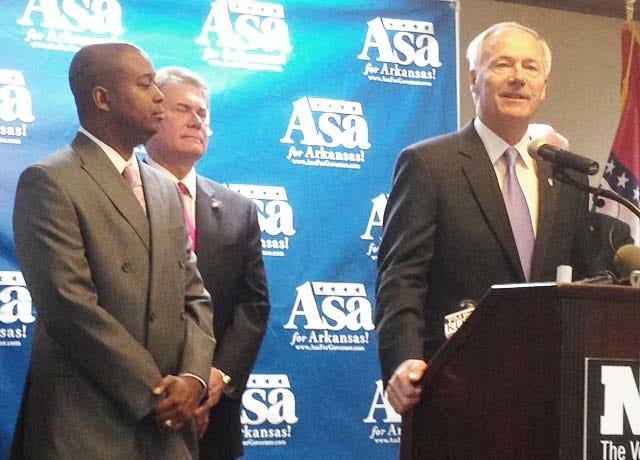 John Lyon • Arkansas News Bureau / Republican gubernatorial candidate Asa Hutchinson speaks at a news conference in Little Rock on Tuesday, Oct. 7, 2014, as, from left, National Federation of Independent Business State Director Sylvester Smith and state Rep. and insurance agent Allen Kerr, R-Little Rock, look on.
