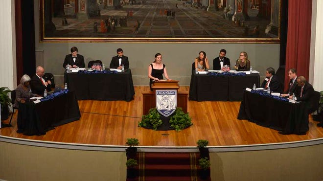 Judges and opposing debaters from Oxford listen to Eilidh Geddes make an argument during a debate between UGA students and members of the Oxford Union Debate Society at the UGA Chapel on Wednesday, Oct. 8, 2014 in Athens, Ga.  (Richard Hamm/Staff) OnlineAthens / Athens Banner-Herald