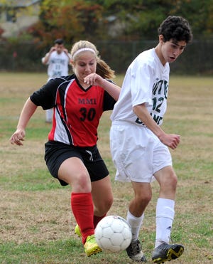 Freeland MMI's Lexi Vanhoeklen, left, and Notre Dame of East Stroudsburg's Liam King during their game at Notre Dame on Tuesday afternoon. For more photos go to www.poconorecord.com/photos. (Melissa Evanko/Pocono Record)