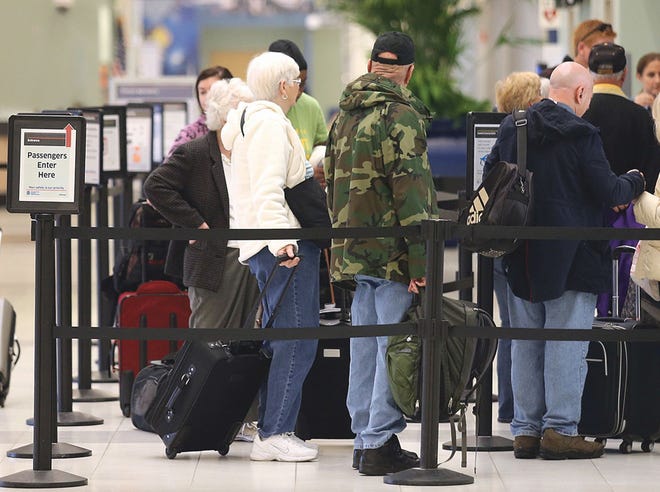 Travelers wait to go through security at Northwest Florida Beaches International Airport.