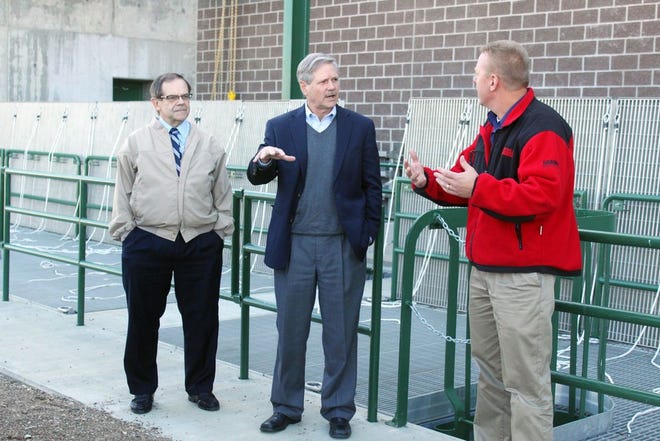 During a visit to a pump station near Devils Lake, mayor Richard Johnson, left, U.S. Senator John Hoeven and city engineer Mike Grafsgaard discuss the embankment project Wednesday morning. City and county officials participated in a tour during Hoeven's visit to the Lake Region.