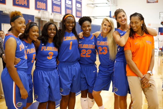 University of Florida women's basketball players, from left, Carla Batchelor, Antoinette Bannister, January Miller, Ronni Williams, Kayla Lewis, Brooke Copeland, Viktorija Dimaite and assistant coach Murriel Page pose for a photo using a player's cell phone during media day on Thursday.