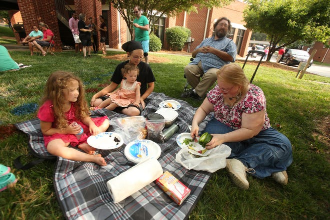 Sarah Mellon with her kids Echo, 2, and Aloe, 4, enjoy a picnic with friends Tony Brown and April Ayers at #ShelbyLoves an event for gay LGBTQ pride held at the Episcopal Church of the Redeemer in Shelby on June 27. The church's pastor, Rev. Dr. Valori Mulvey Sherer supports overturning North Carolina's ban on same sex marriage. (Ben Earp/The Star)