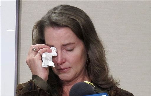 Cylvia Hayes, fiancee of Oregon Gov. John Kitzhaber, cries as she speaks at a news conference in Portland, Ore. on Thursday, Oct. 9, 2014. Hayes has admitted that she violated the law when she married an immigrant seeking to retain residency in the United States. She said she was "associating with the wrong people" while struggling to put herself through college and regrets her actions. (AP Photo/Gosia Wozniacka)
