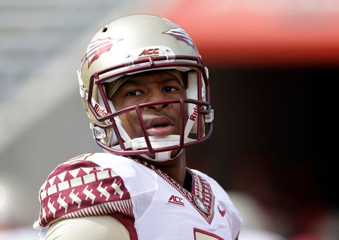 In this Sept. 27 file photo, Florida State's quarterback Jameis Winston warms up prior to an NCAA college football game against North Carolina State in Raleigh, N.C. Florida State University released a document Friday morning defending itself in the handling of the sexual assault investigation of quarterback Jameis Winston, detailing its own timeline of events. (AP Photo/Gerry Broome, File)