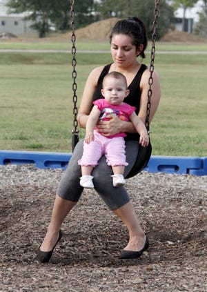 Jamie Mitchell • Times Record - Carleen Ramos swings with her 8-month-old daughter, Mia, Thursday, October 09, 2014, during a family visit to Ben Geren Park.