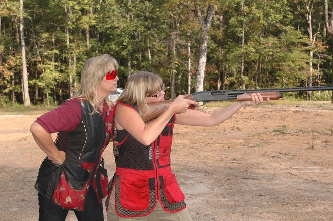 Rebekah Okins, right, gets tips on the trap range from certified instructor Rhonda Geiger-Cole during the recent Becoming an Outdoorswoman event at the Alabama 4-H Center near Columbiana. The program is designed to teach women outdoor skills.