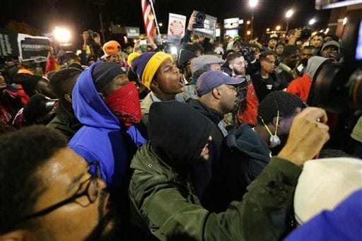 Demonstrators rally in Ferguson on Friday, Oct. 10, 2014, as part of a weekend of planned protests called Ferguson October. (AP Photo/St. Louis Post-Dispatch, Robert Cohen)