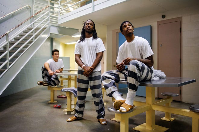 Boone County Jail inmates Darian Carter, center, Lamont Cooper Jr., right, and an inmate who asked not to be identified watch an episode of “Dr. Phil” while in a housing unit at the jail on Thursday. The number of jail bookings is on pace for a 15-year low.