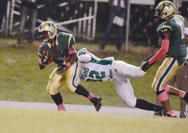 Kinston's Jeremiah Fields (1) is tackled by North Lenoir's Dominique Mitchell (32) in the second quarter Friday at Kinston High School.