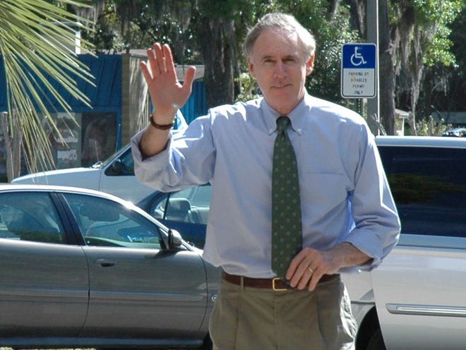 March 24, 2007--Gainesville,Florida - U. S. Rep. Cliff Stearns, R-Ocala, waves as he walks through Gainesville High School Saturday morning to attend one of four town meetings he was hosting in the city on Saturday.