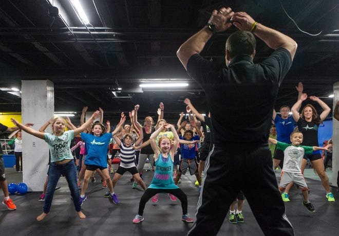 Martin Rooney, founder of Training For Warriors, drills attendees Thursday, Oct. 2, 2014, with jumping jacks for a warm-up during the charity boot camp workout at Maximum Performance Fitness Training.
