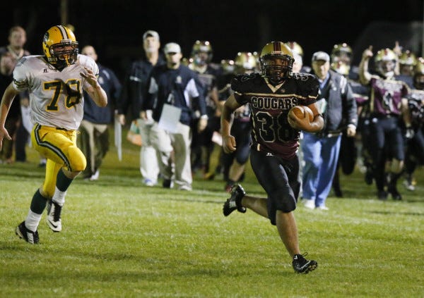 Cole Bernier pulls away from a South Shore Voke defender on his way to a second-quarter touchdown.