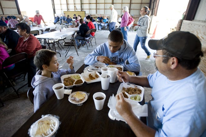 Diners enjoy the pulled pork produced by competitors in the  Vander Pig Cook-off in 2010. The competition returns next weekend for its 11th year.