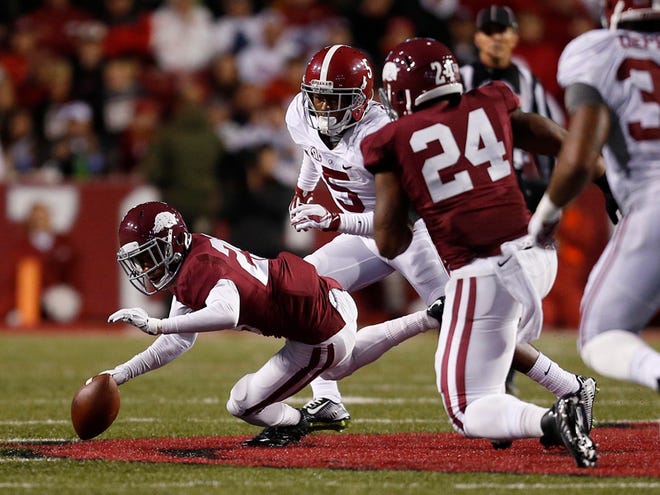 Players chase after a loose ball in the fourth quarter that was eventually recovered by Alabama linebacker Trey DePriest.