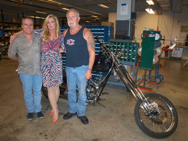 From left, Orange County Chopperís Cafe entertainment director Mark Gamma; Joannie Kay, OCC Advisory Board member; and Paul Teutul Sr. stand in the bike shop. They are excited about the direction that the cafe is taking. (Donna Kessler/For Pocono Record)
