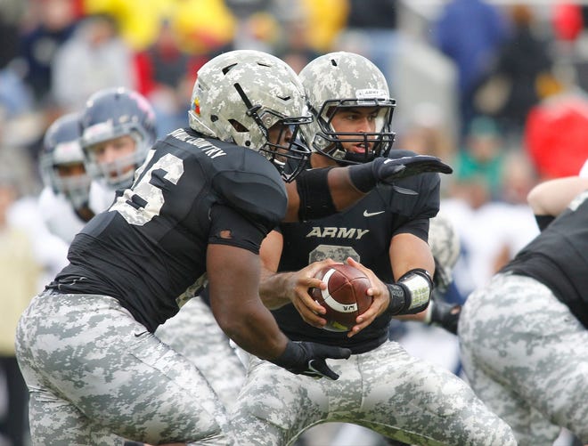 Army fullback Larry Dixon, left, was injured late in Saturday's game against Rice. Dixon, who rushed for 86 yards and scored one touchdown in the 41-21 loss, said after the game that he was OK. JOHN MEORE/For the Times Herald-Record.