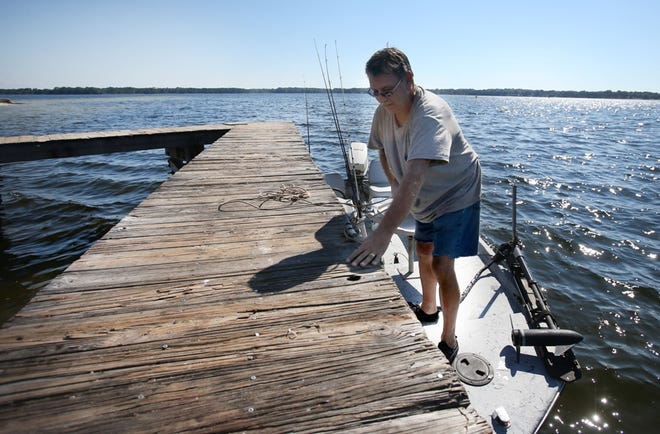Robert Eldridge ties his boat to a small pier in Earl Gilbert Park on Friday. Parker will receive money to build piers, boat ramps and docks.
