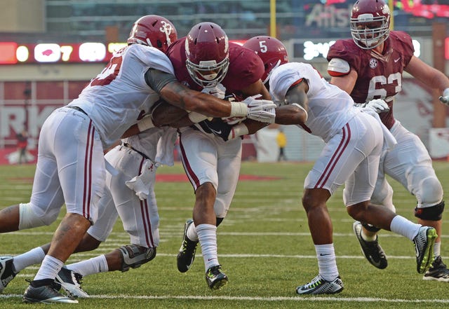 BRIAN D. SANDERFORD • TIMES RECORD University of Arkansas’ Jonathan Williams drives through Alabama defenders Paden Crowder, left, and Cyrus Jones for a touchdown during the second quarter on Saturday, Oct. 11, 2014 in Fayetteville.