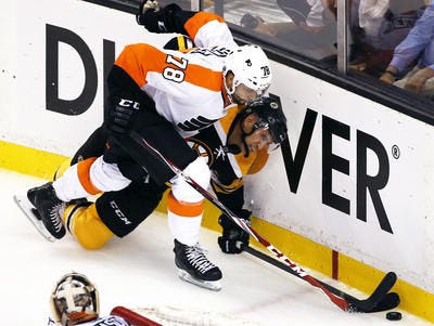 Philadelphia Flyers right wing Pierre-Edouard Bellemare (78) and Boston Bruins center Bobby Robins, right, battle for the puck along the boards in the third period of an NHL hockey game in Boston, Wednesday, Oct. 8, 2014. The Bruins won 2-1. (AP Photo/Elise Amendola)