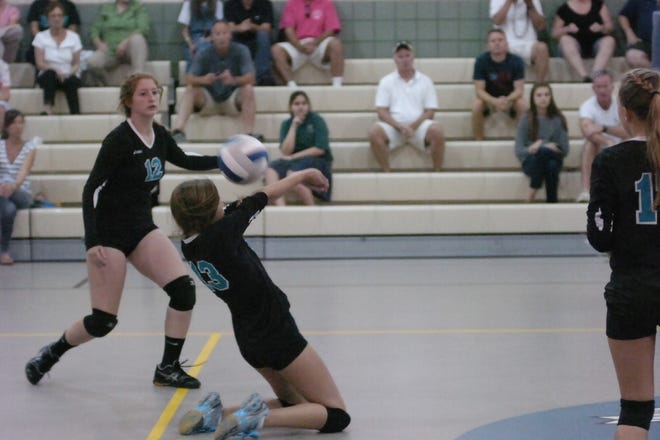 Destin's Elise Fogg goes down on her knees to dig out the ball.