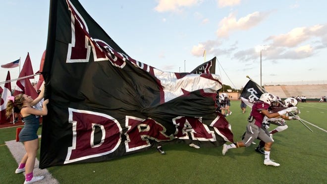 Dragons take the field during the game between Rouse and Round Rock at Dragon Stadium in Round Rock, October 10, 2014. Henry Huey for Round Rock Leader.