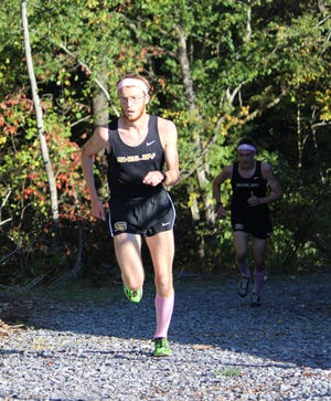 Shelby High's Blanton Gillespie leads the pack at the SMAC championship meet on the SHS 5,000-meter campus course Wednesday. Gillespie was the boys' individual winner while the Golden Lion boys and the Kings Mountain girls claimed league honors. (Special to The Star)