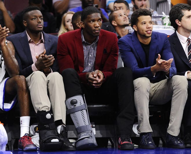 The 76ers' (from left) Jerami Grant, Joel Embiid and Michael Carter-Williams look on during an Oct.8 preseason game against the Hornets.