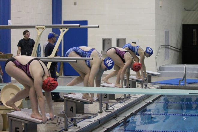 Waverly and Ionia swimminers line up for the 400-yard freestyle relay race on Thursday night.