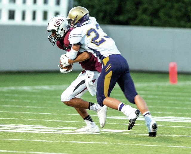 ANTHONY REYES • NWA MEDIA / Booneville's Matthew Berry tackles Springdale's Salvador Sandoval on Monday, Aug. 25, 2014, during a scrimmage at Bulldog Stadium in Springdale.