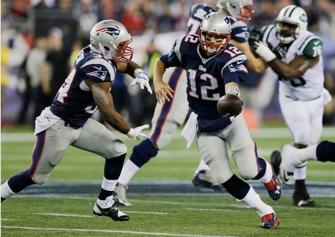 New England Patriots quarterback Tom Brady (12) hands off to running back Shane Vereen in the first half of an NFL football game Thursday, Oct. 16, 2014, in Foxboro.