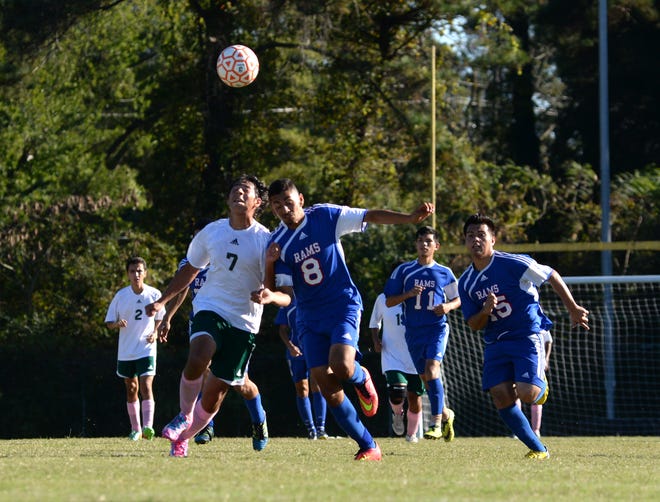 Kinston's Julian Quintero (7) and Greene Central's Abelardo Trejo (8) battle for the ball in Friday's soccer match at Kinston High School.