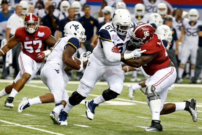 Alabama defensive lineman A'Shawn Robinson (86) blocks West Virginia offensive lineman Quinton Spain (67)during the first half of the Chick-fil-A Kick Off Game in the Georgia Dome in Atlanta, Ga. Saturday, Aug. 30, 2014. Michelle Lepianka Carter | The Tuscaloosa News