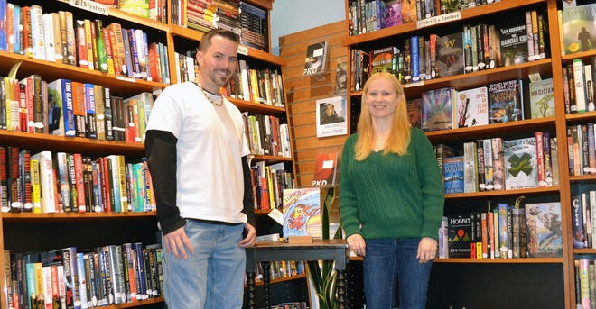 Tim Workman, 37, and Stephanie Workman, 35, stand in RiverRun Bookstore in Portsmouth with Stephanie's new book “Lucy's Amazing Friend.”