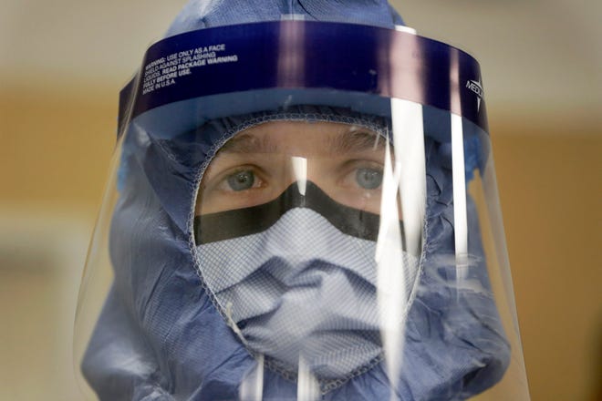 Registered nurse Keene Roadman, stands fully dressed in personal protective equipment during a Thursday training class at the Rush University Medical Center in Chicago. Locally, hospital staff and emergency responders are making sure they are equipped to handle a patient with Ebola.

(AP Photo/Charles Rex Arbogast)