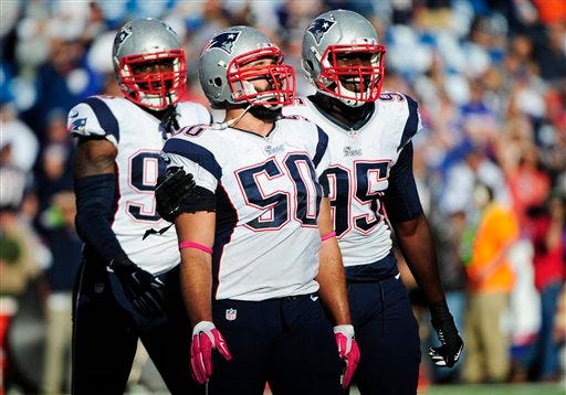 New England Patriots' Zach Moore (90), Rob Ninkovich (50), and Chandler Jones celebrate a sack by Ninkovich during the second half of last Sunday's win over the Buffalo Bills. AP photo