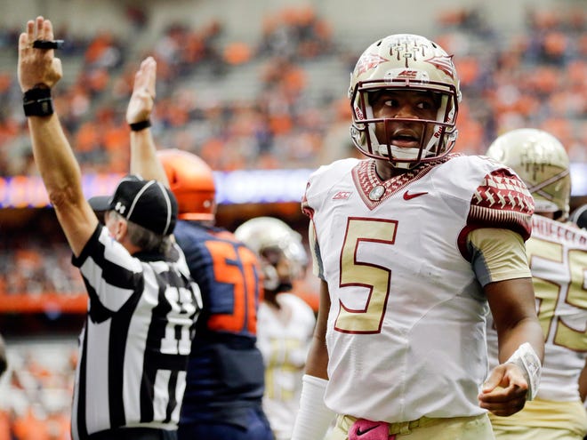 Florida State quarterback Jameis Winston (5) talks to Syracuse's Darius Kelly, not shown, after teammate Dalvin Cook scored a touchdown during the second half on Oct. 11 in Syracuse, N.Y. (AP Photo/Frank Franklin II)