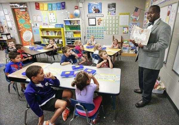 Aarion Gray, principal at Logan Elementary, reads to a kindergarten class. Gray and his counterparts in the Seaman USD 345 are part of an evaluation process the district is undergoing this fall to find ways to be more efficient and effective in educating students.