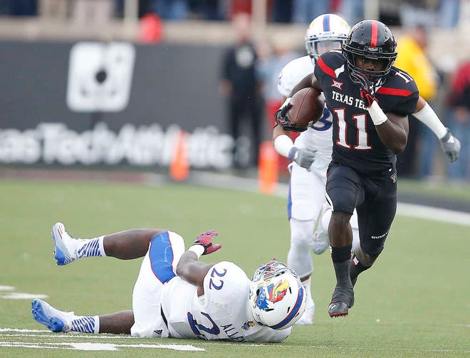 Texas Tech's Jakeem Grant gets past Kansas' Greg Allen (22) and Cassius Sendish (33) during a NCAA college football game Saturday in Lubbock, Texas. Texas Tech won 34-21.